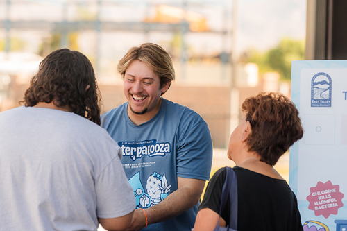 District staff demonstrating how to pull a water sample at Waterpalooza.